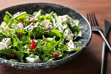 Bowl with arugula salad, closeup