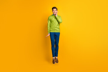 Full length body size profile side view of nice funky glad delighted cheerful guy jumping having fun isolated on bright yellow color background