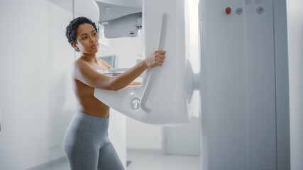 Fototapeta na wymiar In the Hospital, Portrait Shot of Topless Latin Female Patient with Short Hair Undergoing Mammography Screening Procedure. Healthy Young Female Does Cancer Preventive Mammogram Scan in Radiology Room.