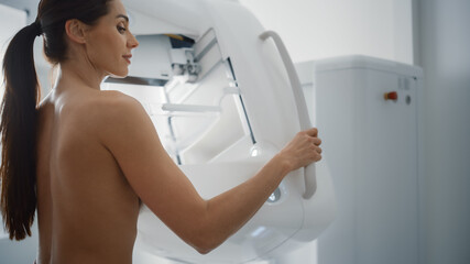 Fototapeta na wymiar In the Hospital, Portrait Shot of Topless Multiethnic Female Patient Undergoing Mammography Screening Procedure. Healthy Adult Caucasian Woman Does Cancer Preventive Mammogram Scan in Radiology Room.