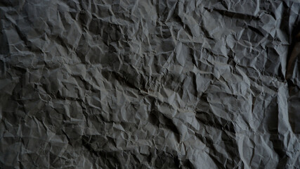Top view photo of Crumpled craft paper. Grey color Paper background with copyspace. Vintage paper canvas texture abstract background.