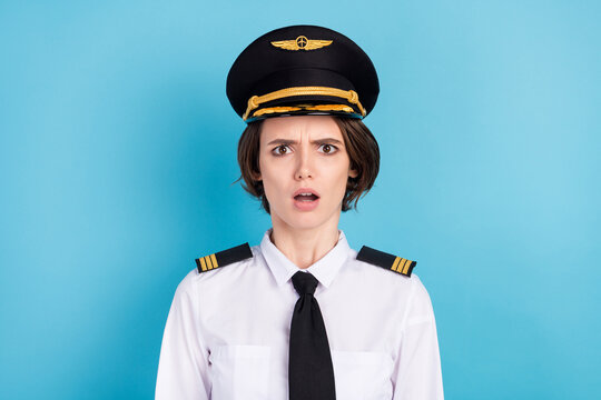 Photo of impressed nice brunette hair lady wear pilot uniform isolated on blue color background