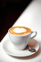 A cup of Latte coffee in a white cup. Close-up, selective focus.
