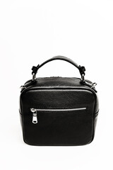 women's handbag in black on a white background. details of a female leather bitch. crocodile skin texture. bag for a business lady. exclusive handbag