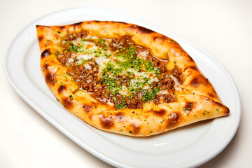Khachapuri meat on a white plate. Close-up, selective focus.