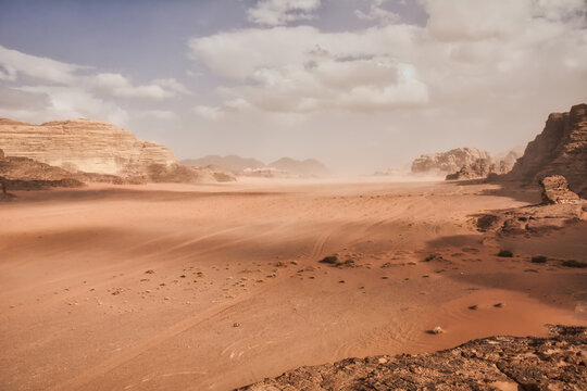 Dramatic desert landscape at Wadi Rum in Jordan with clouds rolling in through the valley