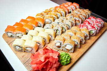 Set of various sushi rolls on a board. Close-up, selective focus.