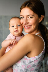 Happy cheerful family. Mother and baby kissing, laughing and hugging