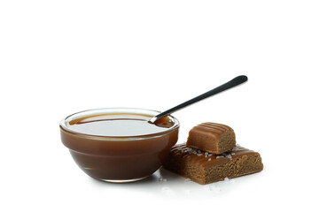 Salted caramel and bowl of sauce isolated on white background