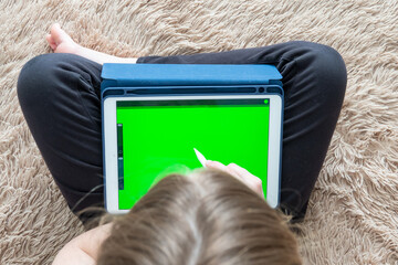 Girl digital artist draws with a stylus on a tablet or laptop. She is a student and is studying...