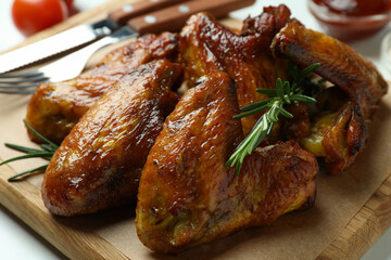 Concept of tasty food with baked chicken wings, close up