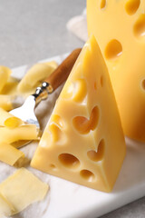 Tasty fresh cheese on white marble board, closeup