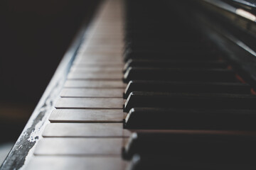 Close up of worn old piano keys with a shallow depth of field.