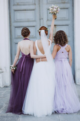 bride with bridesmaids hugging