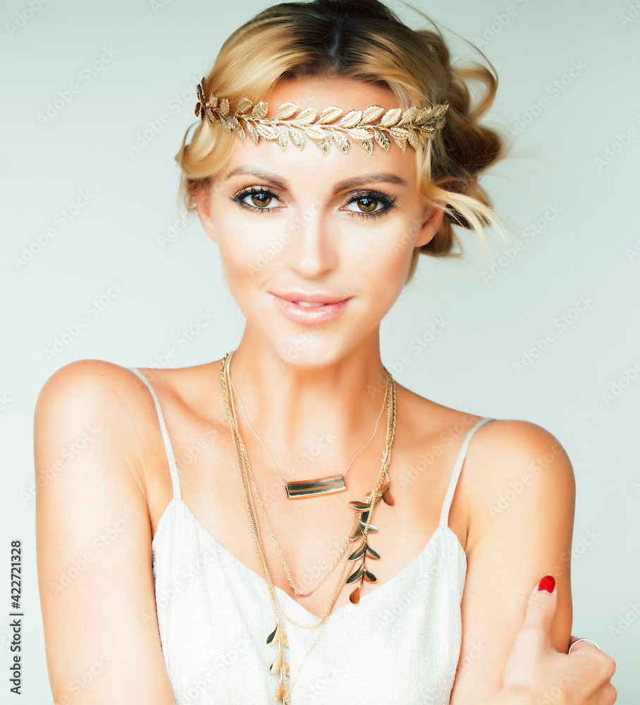 Wall mural young blond woman dressed like ancient greek godess, gold jewelry close up isolated, summer trends