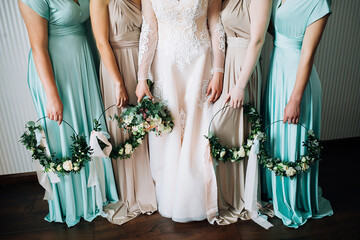 closeup bride with bouquet and bridesmaids with wreaths