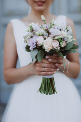 hands of the bride with a bouquet