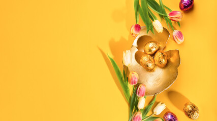 Stylish background with gold easter eggs on the yellow color background Horizontal long banner for web design Flat lay top view mockup overhead template