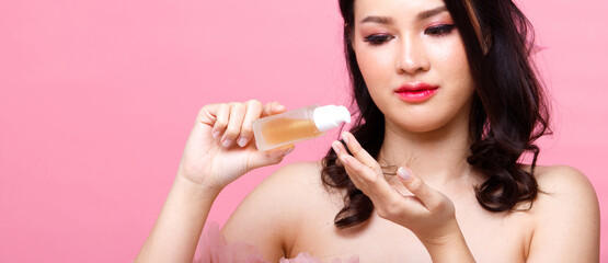 Portrait of Asian girl wear pink dress over pink tone background