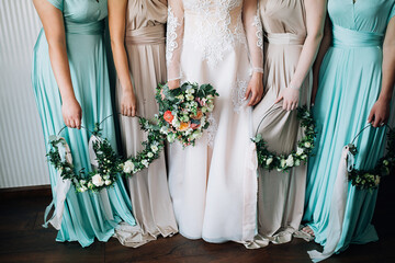 closeup bride with bouquet and bridesmaids with wreaths