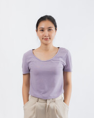 A portrait of young and cute Asian girl wearing t-shirt and pose on white background with friendly face and positive emotion