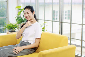 Young and beautiful Asain woman sitting and demonstrat and communicate with hand sign, deaf language.