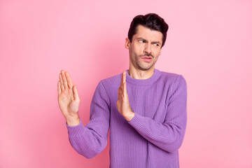 Photo of annoyed upset young guy wear violet sweater ask not touch him isolated pastel pink color...