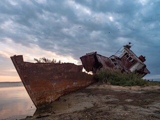 A close-up of an old abandoned ship on the shores of the drying up Aral Sea. Kazakhstan. The ship was sawn for scrap by local residents. Ecological disaster of the Aral Sea