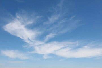 Naklejka na ściany i meble Bright white clouds over blue sky