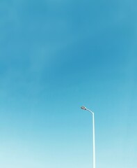 road lamp against blue sky