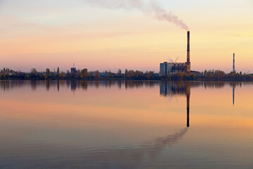 Fototapeta premium Kyiv recycling plant at sunset. chimney smokes. lake Vyrlytsia, Kiev, Ukraine