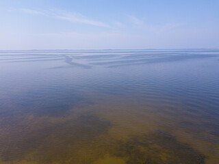 The Gulf of Riga, the Curonian Spit can be seen in the distance. Sunset, quiet summer evening. Photo from the drone ER