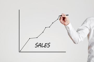 Businessman hand draws a rising line with the word job sales. Increasing or growing sales