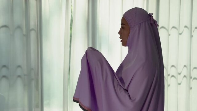 Muslim women praying In the foyer of the house during the coronavirus (COVID-19) outbreak, quarantine concept.