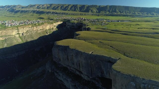 Helicopter flight epic deep grand canyon Tobot waterfall Dagestan green rural nature landscape. Incredible Caucasus traditional aul settlement on edge of cliff. Russia travel landmark