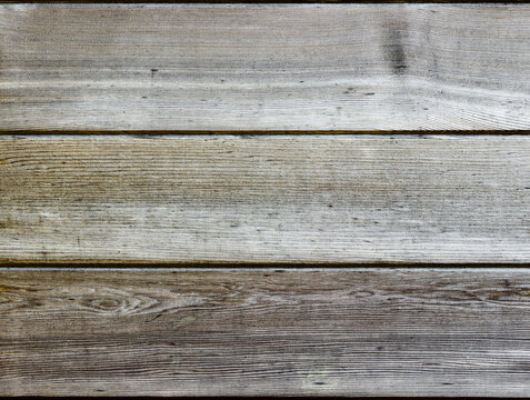 Three horizontal natural wooden panels light and silver in colour
