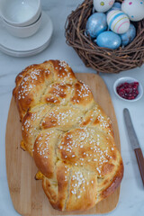 Sweet home made braided yeast bun for easter on a table