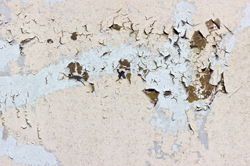 Detail of peeling, cracked and flakey paint on a metal surface