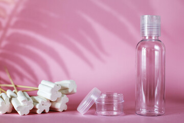 spa cosmetic products with sweets, transparent empty tube on pink background. bottle for detergent cleaning agent
