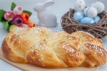 Sweet home made braided yeast bun for easter on a table