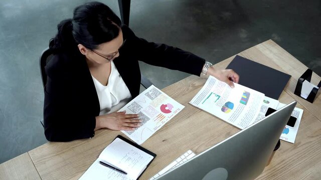 high angle view of asian businesswoman working in modern office