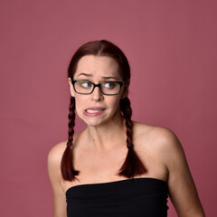 close up portrait of red haired women with different facial expressions on a pink studio background.