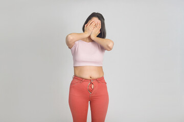 Fototapeta premium Upset young woman with slightly overweight. Diet, overweight, obesity concept