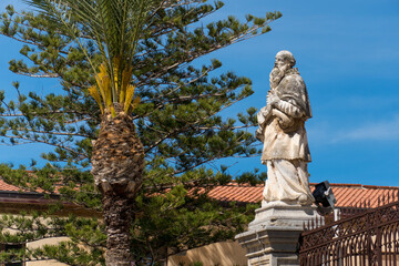 Fototapeta na wymiar Marble statue outside of the Cathedral of Cefalù, Sicily, Italy, Roman Catholic basilica