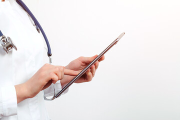 Woman doctor using tablet computer. Doctor reading patient report. Mock-up with copy space.