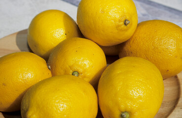 dish of imperfect lemons in sunshine