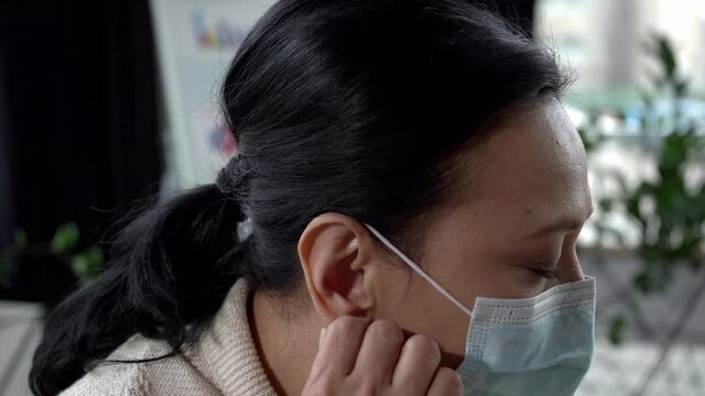 Slow-motion Of Asian Woman Taking Off Medical Mask And Smiling In Office