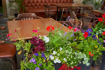 empty restaurant table with flowers,beautiful wooden table with flowers at a street cafe