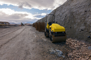 Obraz na płótnie Canvas A mini steamroller at a road construction site