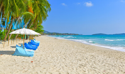 Beach umbrella and lounge chairs at Chaweng beach in koh samui ,Thailand.